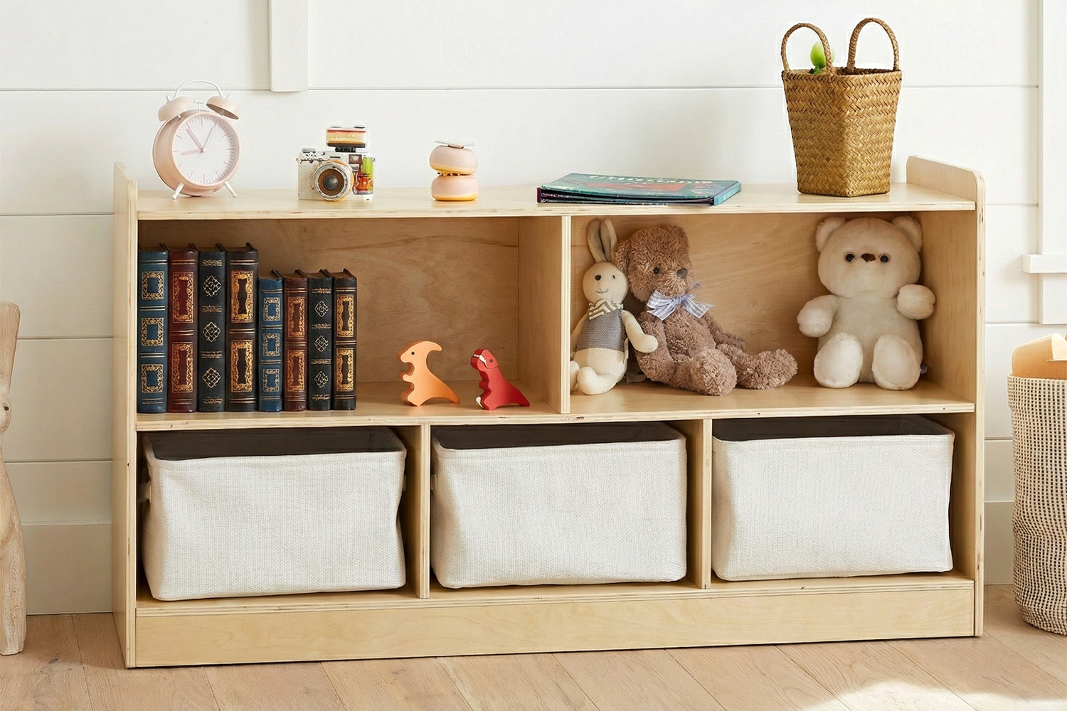 Wooden toy storage shelf with books, plush toys and 3 fabric bins